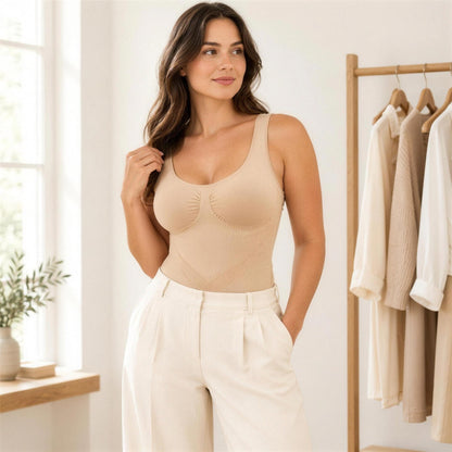 Woman wearing the SVELT Shaping Bodysuit in Beige with cream trousers